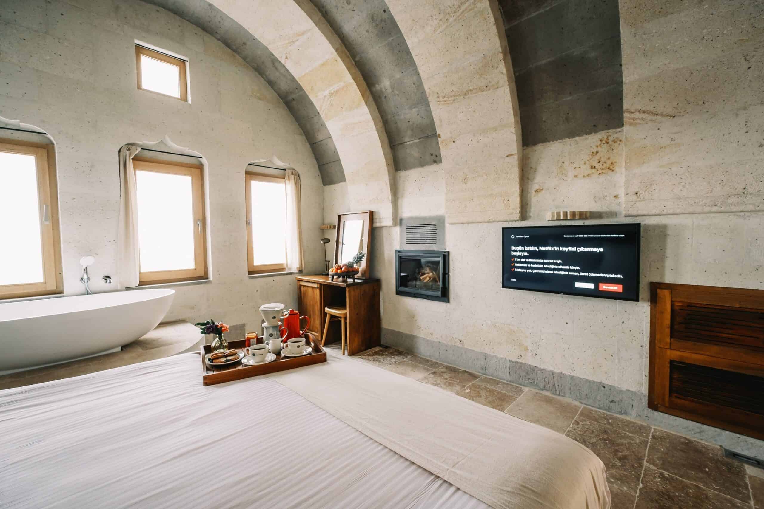 Millstone Cave Suites junior suite with a view, featuring a bathtub and a fireplace.