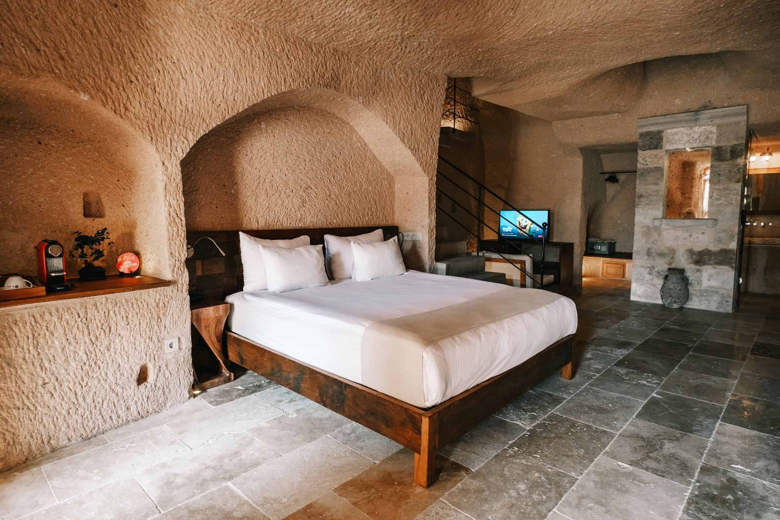 Millstone Cave Suites Superior King Suite features a cave room with a fireplace and a jacuzzi.