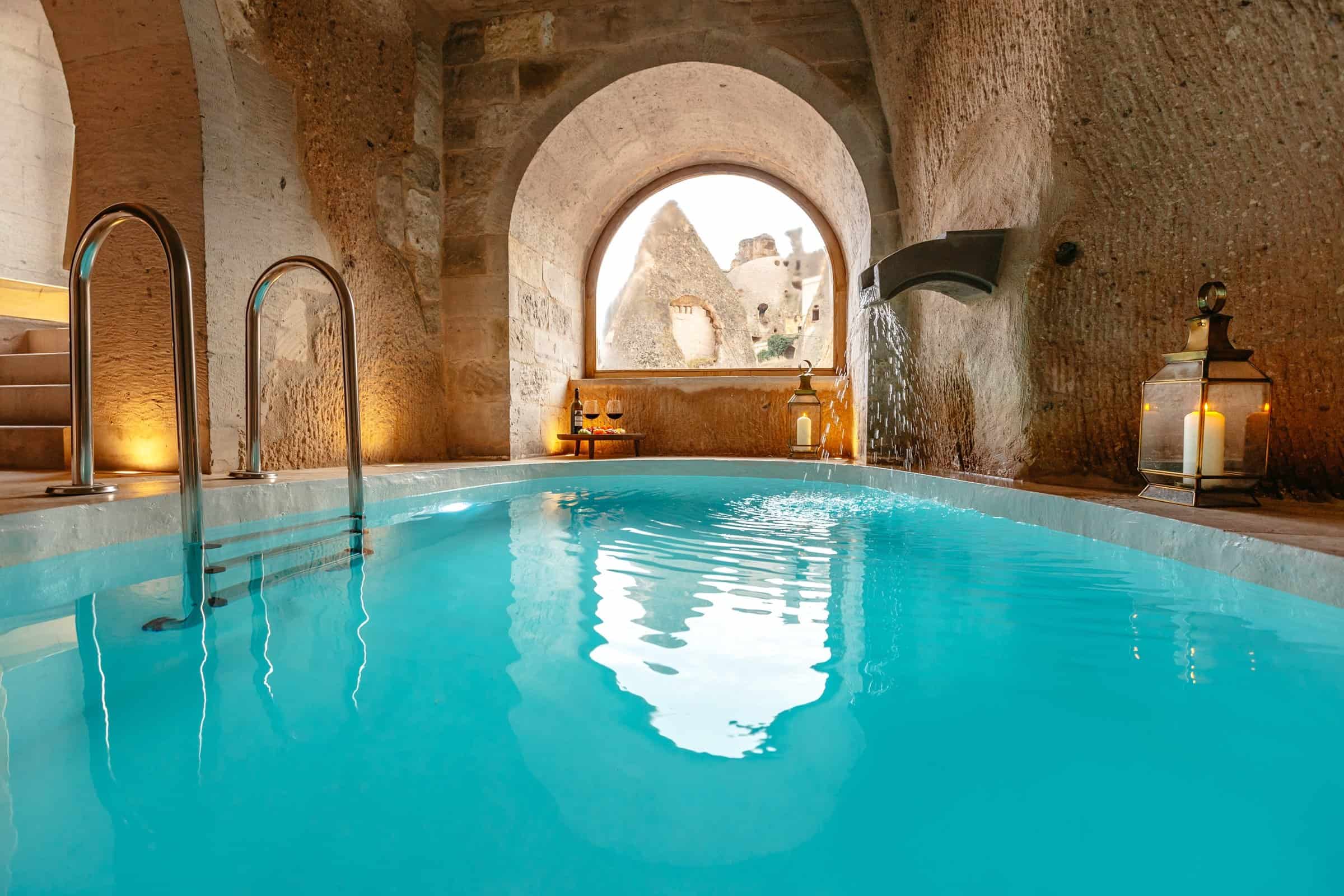 Millstone Cave Suites: a spacious cave suite featuring a cave room with a fireplace and an indoor pool.