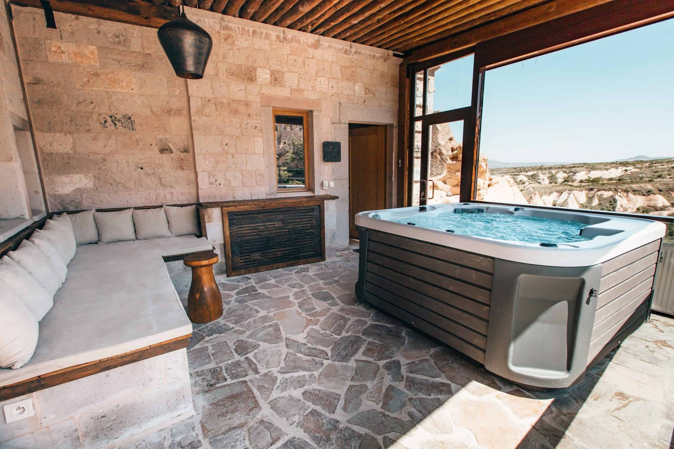 Millstone Cave Suites hot tub suite features a hot tub and fireplace with views of the fairy chimneys.