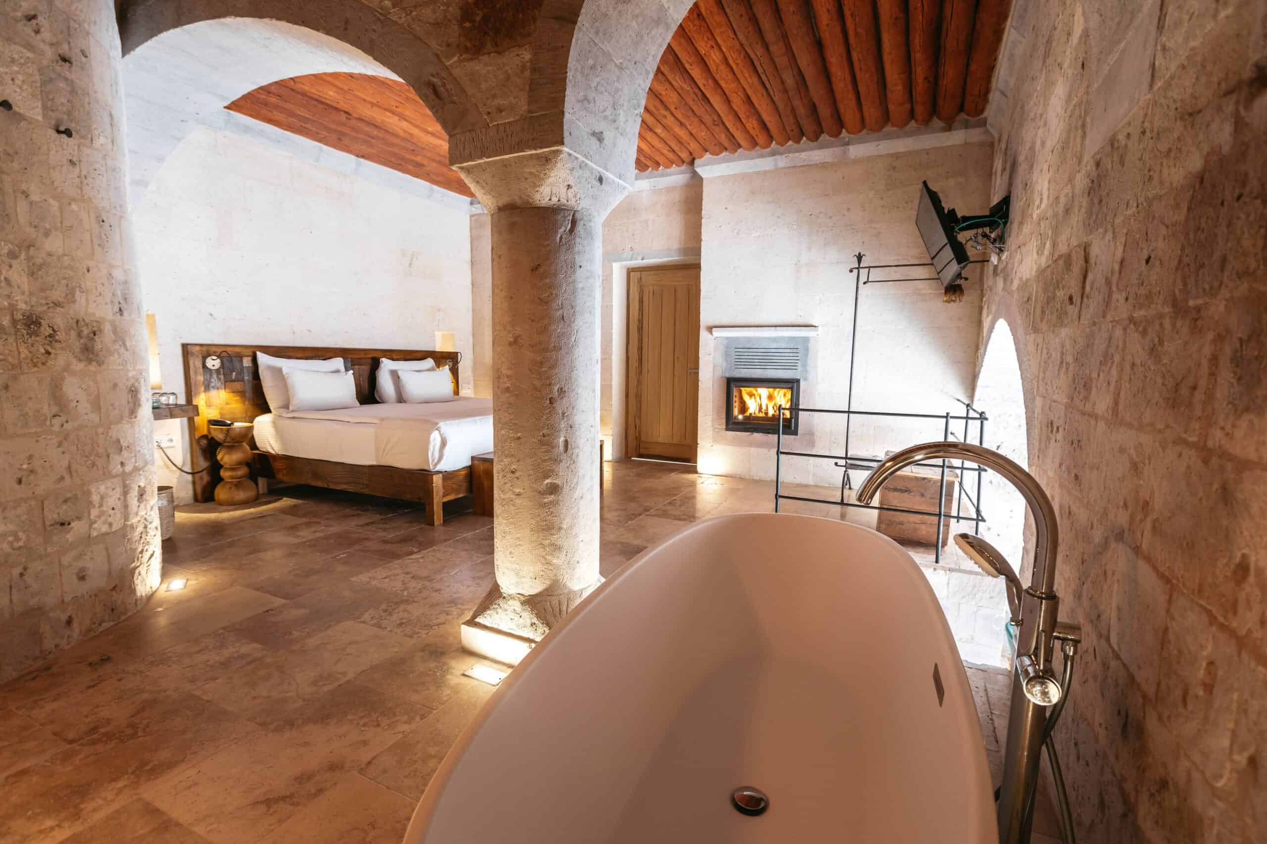 The Millstone Cave Suite features a semi-open pool, bathtub, and fireplace.