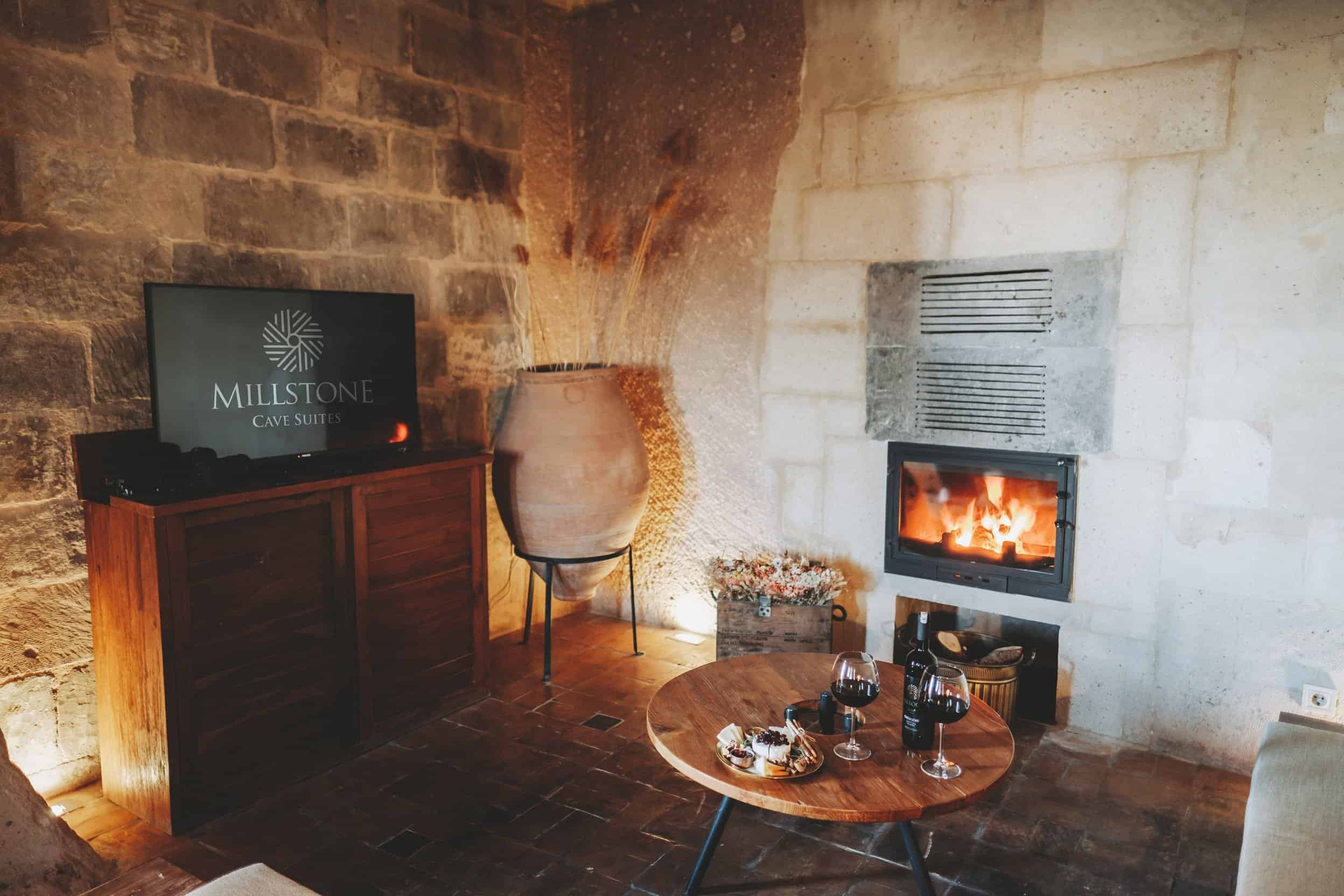 Millstone Cave Suite king suite has a cave room with a fireplace.