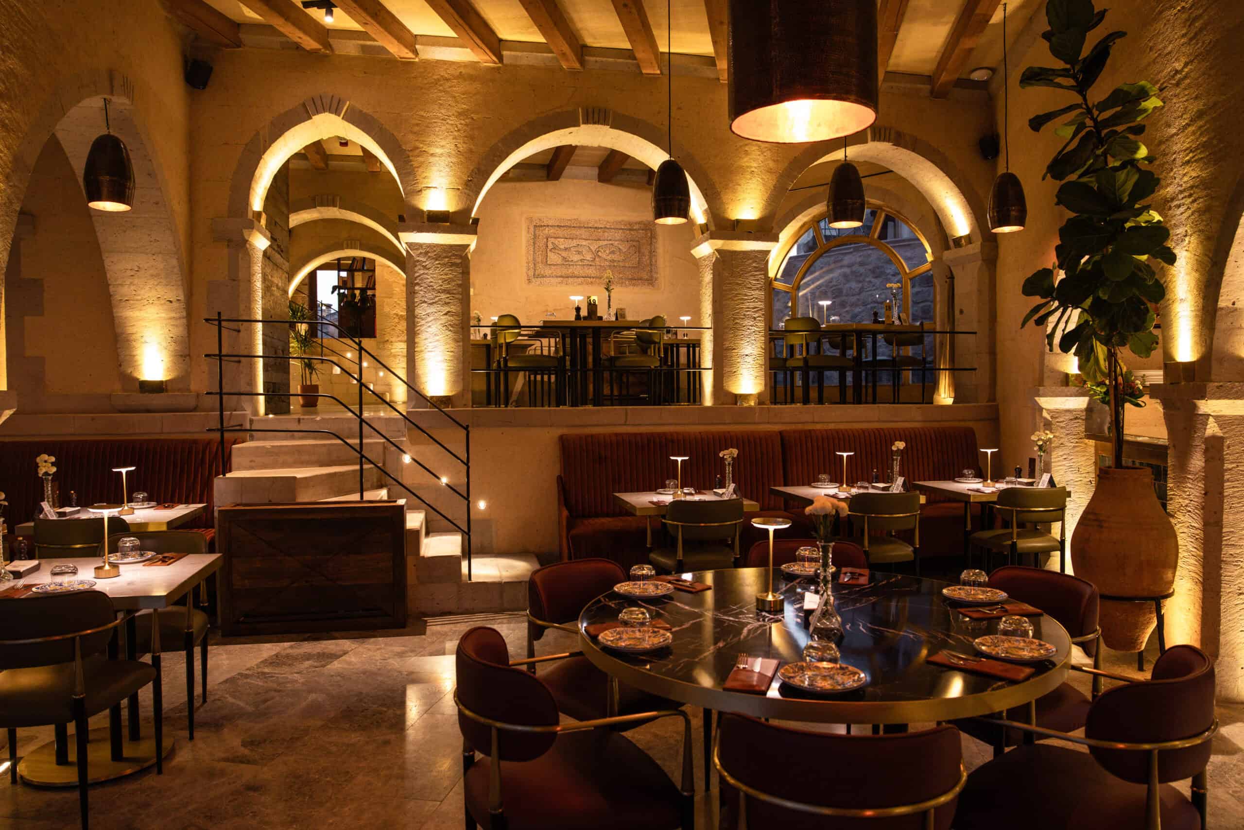 Seating area with a fireplace and valley view at Millstone Cave Suites' Millitaly Restaurant.
